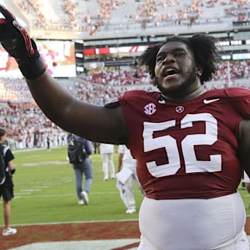 Sep 23, 2023; Tuscaloosa, Alabama, USA;  Alabama Crimson Tide offensive lineman Tyler Booker (52) celebrates as he leaves the field at Bryant-Denny Stadium. Alabama defeated Mississippi 24-10.