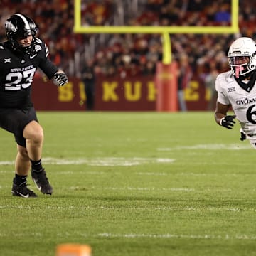 Nov 16, 2024; Ames, Iowa, USA; Cincinnati Bearcats running back Evan Pryor (6) runs away from Iowa State Cyclones  Carson Robbins (23) in the first half at Jack Trice Stadium. Mandatory Credit: Reese Strickland-Imagn Images