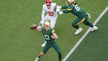 Nov 29, 2025; Waco, Texas, USA;  Baylor Bears quarterback Sawyer Robertson (13) passes the ball as Houston Cougars defensive lineman Eddie Walls III (90) gives chase during the first half at McLane Stadium. Mandatory Credit: Chris Jones-Imagn Images