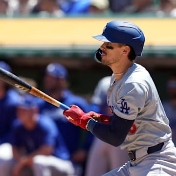 Aug 4, 2024; Oakland, California, USA; Los Angeles Dodgers first baseman Cavan Biggio (6) hits an RBI single against the Oakland Athletics during the third inning at Oakland-Alameda County Coliseum. Mandatory Credit: Darren Yamashita-Imagn Images