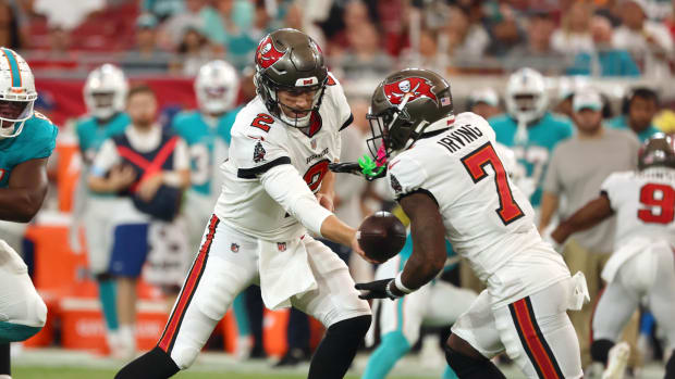 Tampa Bay Buccaneers quarterback Kyle Trask (2) hands the ball off to running back Bucky Irving (7) against the Miami Dolphin