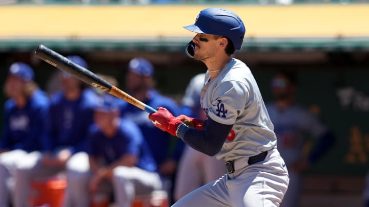 Aug 4, 2024; Oakland, California, USA; Los Angeles Dodgers first baseman Cavan Biggio (6) hits an RBI single against the Oakland Athletics during the third inning at Oakland-Alameda County Coliseum. 