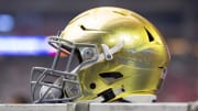 Jan 1, 2022; Glendale, Arizona, USA; Detailed view of a gold Notre Dame Fighting Irish helmet during the 2022 Fiesta Bowl at State Farm Stadium.
