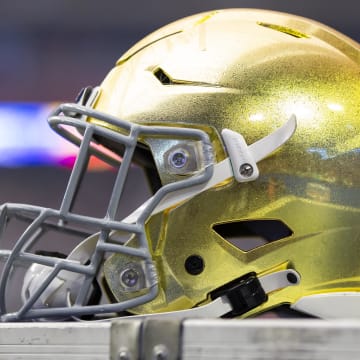 Jan 1, 2022; Glendale, Arizona, USA; Detailed view of a gold Notre Dame Fighting Irish helmet during the 2022 Fiesta Bowl at State Farm Stadium.