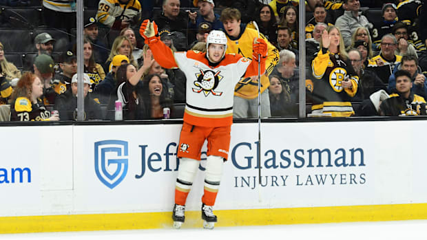 Hockey player in white uniform celebrates