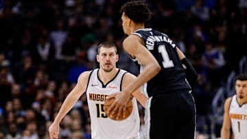 Jan 3, 2025; Denver, Colorado, USA; San Antonio Spurs center Victor Wembanyama (1) controls the ball as Denver Nuggets center Nikola Jokic (15) guards in the third quarter at Ball Arena. Mandatory Credit: Isaiah J. Downing-Imagn Images