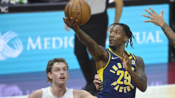 Oct 10, 2024; Cleveland, Ohio, USA; Indiana Pacers guard Quenton Jackson (29) drives to the basket beside Cleveland Cavaliers guard Luke Travers (33) in the fourth quarter at Rocket Mortgage FieldHouse. Mandatory Credit: David Richard-Imagn Images
