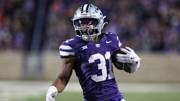 Nov 23, 2024; Manhattan, Kansas, USA; Kansas State Wildcats running back DJ Giddens (31) carries the ball during the fourth quarter against the Cincinnati Bearcats at Bill Snyder Family Football Stadium. Mandatory Credit: Scott Sewell-Imagn Images