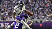 Nov 9, 2025; Minneapolis, Minnesota, USA; Baltimore Ravens quarterback Lamar Jackson (8) runs the ball as Minnesota Vikings cornerback Isaiah Rodgers (2) makes the tackle during the third quarter at U.S. Bank Stadium. Mandatory Credit: Jeffrey Becker-Imagn Images