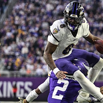 Nov 9, 2025; Minneapolis, Minnesota, USA; Baltimore Ravens quarterback Lamar Jackson (8) runs the ball as Minnesota Vikings cornerback Isaiah Rodgers (2) makes the tackle during the third quarter at U.S. Bank Stadium. Mandatory Credit: Jeffrey Becker-Imagn Images