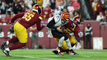 Aug 18, 2025; Landover, Maryland, USA; Cincinnati Bengals quarterback Joe Burrow (9) is sacked by Washington Commanders defensive end Dorance Armstrong (92) and Washington Commanders defensive end Jacob Martin (55) during the first half at Northwest Stadium. Mandatory Credit: Amber Searls-Imagn Images