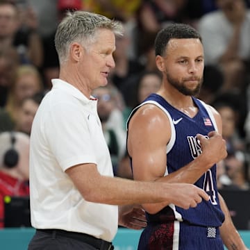 United States head coach Steve Kerr talks to shooting guard Stephen Curry.