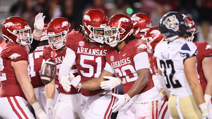 Nov 18, 2023; Fayetteville, Arkansas, USA; Arkansas Razorbacks running back Dominique Johnson (20) celebrates with offensive lineman Devon Manuel (51) after rushing for a touchdown in the second quarter against the FIU Panthers at Donald W. Reynolds Razorback Stadium. Mandatory Credit: Nelson Chenault-Imagn Images