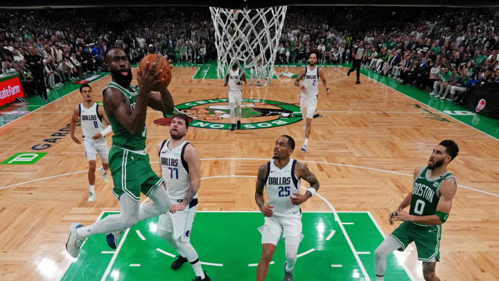 Jun 17, 2024; Boston, Massachusetts, USA; Boston Celtics guard Jaylen Brown (7) shoots the ball against Dallas Mavericks guard Luka Doncic (77) in game five of the 2024 NBA Finals at TD Garden. Mandatory Credit: Peter Casey-USA TODAY Sports