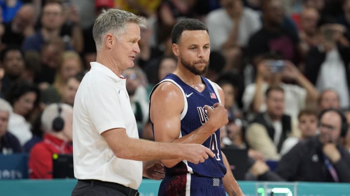 Aug 3, 2024; Villeneuve-d'Ascq, France; United States head coach Steve Kerr talks to guard Stephen Curry (4) in the second quarter against Puerto Rico during the Paris 2024 Olympic Summer Games at Stade Pierre-Mauroy. 