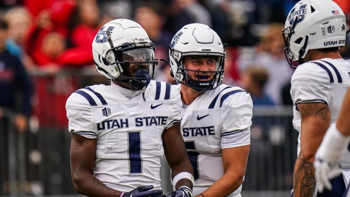 Sep 30, 2023; East Hartford, Connecticut, USA; Utah State Aggies wide receiver Jalen Royals (1) is congratulated by quarterback Cooper Legas (5) after running the ball for a touchdown against the UConn Huskies in the second half at Rentschler Field at Pratt & Whitney Stadium. Mandatory Credit: David Butler II-USA TODAY Sports