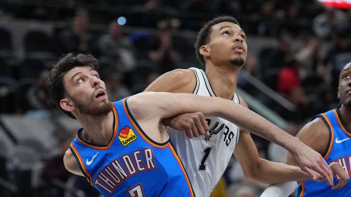 Feb 29, 2024; San Antonio, Texas, USA;  Oklahoma City Thunder forward Chet Holmgren (7) and San Antonio Spurs center Victor Wembanyama (1) battle for position in the first half at Frost Bank Center. Mandatory Credit: Daniel Dunn-USA TODAY Sports