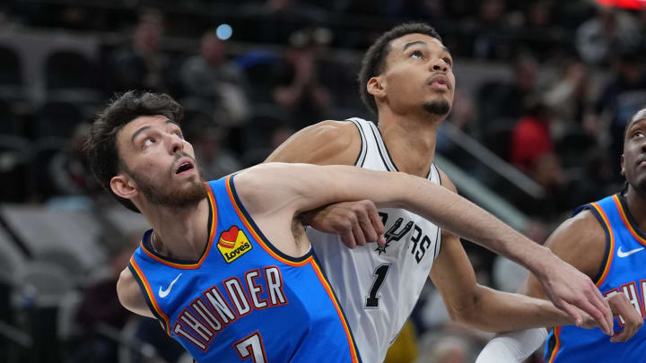 Feb 29, 2024; San Antonio, Texas, USA;  Oklahoma City Thunder forward Chet Holmgren (7) and San Antonio Spurs center Victor Wembanyama (1) battle for position in the first half at Frost Bank Center. Mandatory Credit: Daniel Dunn-USA TODAY Sports