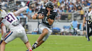 Nov 2, 2024; Orlando, Florida, USA; UCF Knights quarterback Dylan Rizk (10) carries the ball against the Arizona Wildcats during the first quarter at FBC Mortgage Stadium. Mandatory Credit: Mike Watters-Imagn Images
