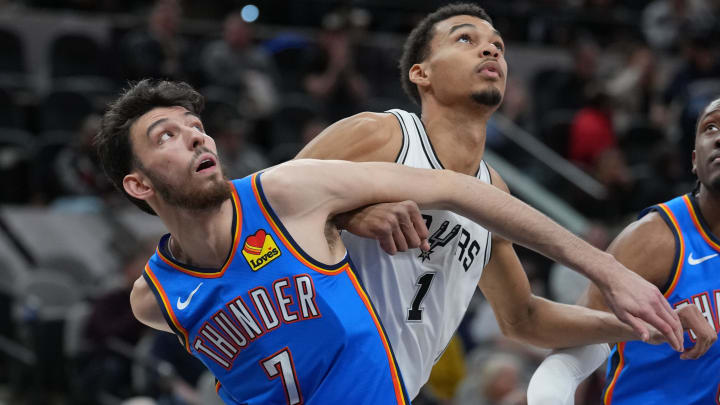 Feb 29, 2024; San Antonio, Texas, USA;  Oklahoma City Thunder forward Chet Holmgren (7) and San Antonio Spurs center Victor Wembanyama (1) battle for position in the first half at Frost Bank Center. Mandatory Credit: Daniel Dunn-USA TODAY Sports