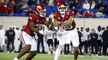 Dec 27, 2024; Memphis, TN, USA; Arkansas Razorbacks quarterback Taylen Green (10) hands the ball off to Arkansas Razorbacks running back Braylen Russell (0) during the forth quarter against the Texas Tech Red Raiders at Simmons Bank Liberty Stadium. Mandatory Credit: Petre Thomas-Imagn Images