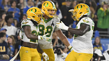 Sep 28, 2024; Pasadena, California, USA; Oregon Ducks Oregon Ducks running back Jordan James (20) celebrates scoring a second quarter touchdown with tight end Patrick Herbert (88) and offensive lineman Josh Conerly Jr. (76) against the UCLA Bruins at Rose Bowl. Mandatory Credit: Robert Hanashiro-Imagn Images