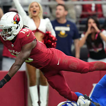 Arizona Cardinals receiver Marvin Harrison Jr. (18) dives in for a touchdown over Los Angeles Rams safety Kamren Curl (3) at State Farm Stadium on Sept. 15, 2024.