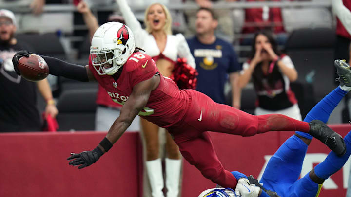 Arizona Cardinals receiver Marvin Harrison Jr. (18) dives in for a touchdown over Los Angeles Rams safety Kamren Curl (3) at State Farm Stadium on Sept. 15, 2024.