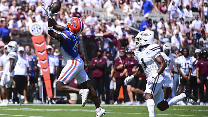 Sep 21, 2024; Starkville, Mississippi, USA; Florida Gators defensive back Jordan Castell (14) attempts to make an interception on a pass intended for Mississippi State Bulldogs wide receiver Kelly Akharaiyi (1) during the during the second quarter at Davis Wade Stadium at Scott Field. Mandatory Credit: Matt Bush-Imagn Images