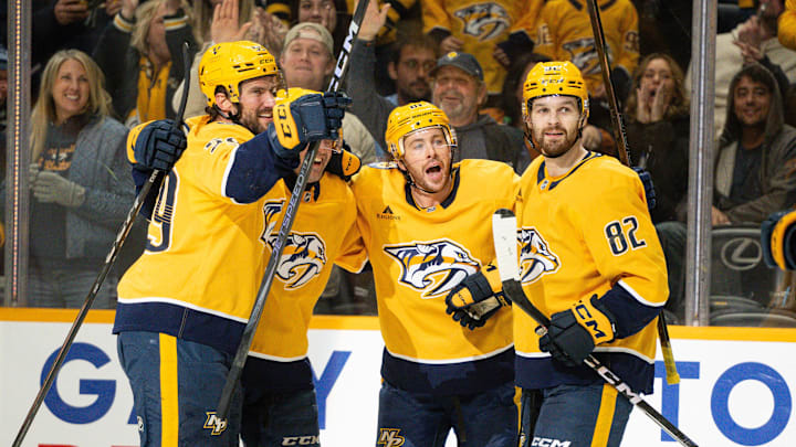 Nov 23, 2024; Nashville, Tennessee, USA;  Nashville Predators center Tommy Novak (82) celebrates his goal with his teammates  against the Winnipeg Jets during the third period at Bridgestone Arena. Mandatory Credit: Steve Roberts-Imagn Images