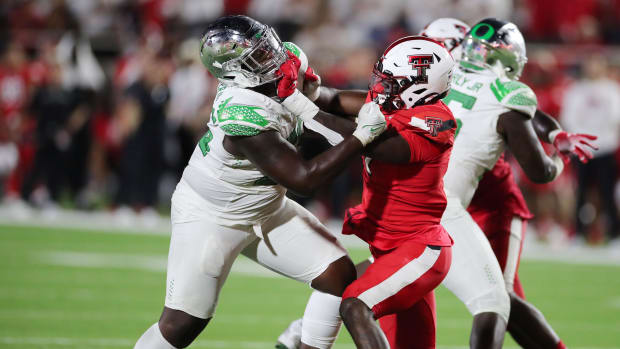 Oregon Ducks offensive guard Marcus Harper II (55) blocks Texas Tech Red Raiders defensive back Steve Linton (7).