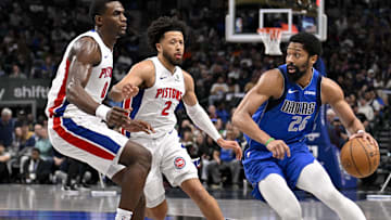 Mar 21, 2025; Dallas, Texas, USA; Dallas Mavericks guard Spencer Dinwiddie (26) moves the ball past Detroit Pistons center Jalen Duren (0) and guard Cade Cunningham (2) during the first quarter at the American Airlines Center. Mandatory Credit: Jerome Miron-Imagn Images