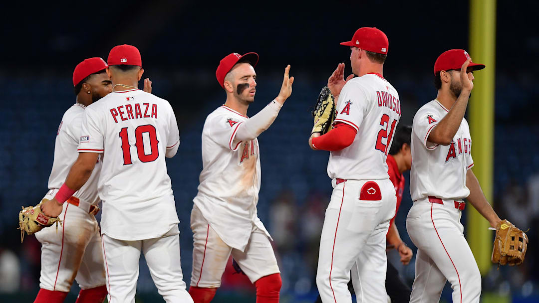 Angels second baseman Luis Rengifo (2), third baseman Oswald Peraza (10), shortstop Zach Neto (9) and first baseman Logan Davidson (21) celebrate the victory against the Minnesota Twins at Angel Stadium on Sept. 9.