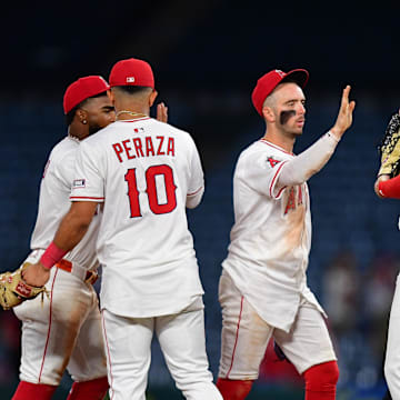 Angels second baseman Luis Rengifo (2), third baseman Oswald Peraza (10), shortstop Zach Neto (9) and first baseman Logan Davidson (21) celebrate the victory against the Minnesota Twins at Angel Stadium on Sept. 9.