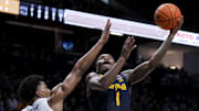 Dec 21, 2024; Cincinnati, Ohio, USA;  Marquette Golden Eagles guard Kam Jones (1) drives to the basket against Xavier Musketeers guard Marcus Foster (1) in the second half at Cintas Center. Mandatory Credit: Aaron Doster-Imagn Images