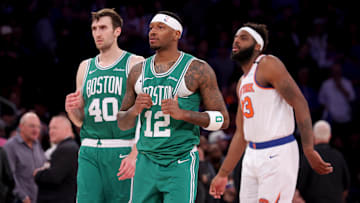 Boston Celtics forward Torrey Craig and center Luke Kornet react in front of New York Knicks center Mitchell Robinson. Mandatory Credit: Brad Penner-Imagn Images