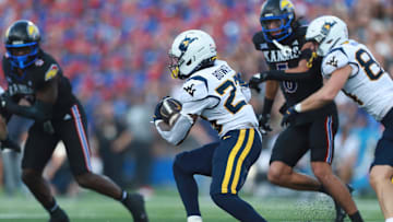 West Virginia Mountaineers running back Cyncir Bowers (23) runs the ball during the first half of the game against Kansas Jayhawks at David Booth Kansas Memorial Stadium on Sept. 20, 2025.