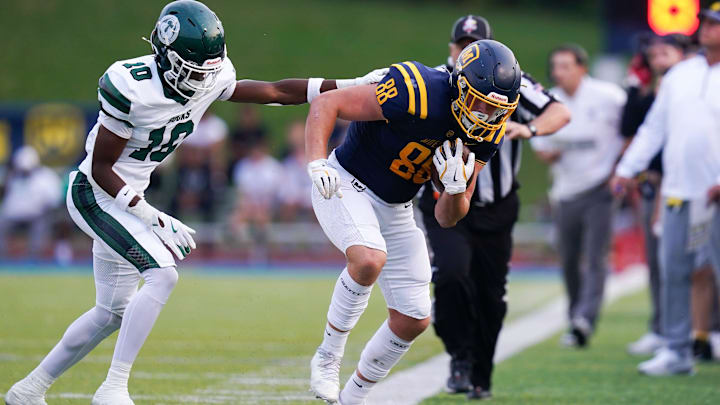 Trinity Shamrocks pushes Moeller Crusaders tight end out-of-bounds in the first half of a high school football game between the Moeller Crusaders and Trinity Shamrocks, Friday, Sept. 5, 2025, at Mount St. Joseph University’s Schueler Field in Cincinnati.