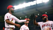 Jo Adell (right) and Luis Rengifo (left) greet each other as Taylor Ward (background) looks on. The three are among the Angels players who could be moved at this year's MLB trade deadline.