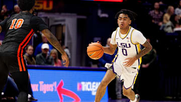 Nov 29, 2024; Baton Rouge, Louisiana, USA;  LSU Tigers guard Vyctorius Miller (0) brings the ball up court against Northwestern State Demons guard Jon Sanders II (10) during the first half at Pete Maravich Assembly Center. Mandatory Credit: Stephen Lew-Imagn Images