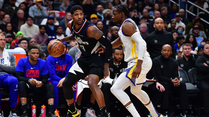 Mar 15, 2023; Los Angeles, California, USA; Los Angeles Clippers forward Paul George (13) moves the ball against Golden State Warriors forward Jonathan Kuminga (00) during the second half at Crypto.com Arena.