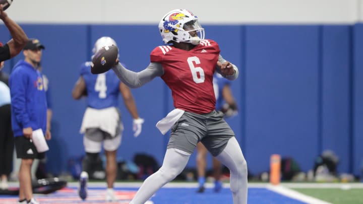 Kansas redshirt junior quarterback Jalon Daniel (6) throws a pass during a team practice Tuesday, April 2, 2024, inside the Indoor Football Practice Facility.