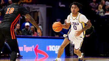 Nov 29, 2024; Baton Rouge, Louisiana, USA;  LSU Tigers guard Vyctorius Miller (0) brings the ball up court against Northwestern State Demons guard Jon Sanders II (10) during the first half at Pete Maravich Assembly Center. Mandatory Credit: Stephen Lew-Imagn Images