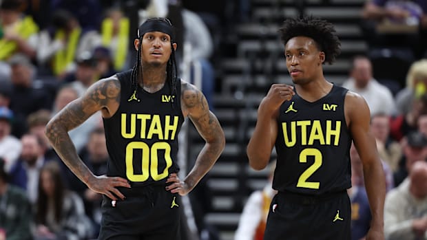 Utah Jazz guard Jordan Clarkson (00) and guard Collin Sexton (2) speak during a second quarter break