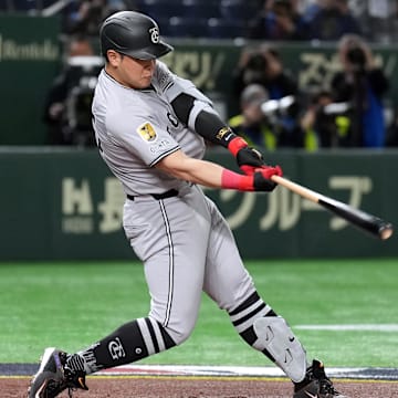 Mar 16, 2025; Bunkyo, Tokyo, Japan; Yomiuri Giants first baseman Kazuma Okamoto (25) hits a single against the Chicago Cubs during the second inning at Tokyo Dome. Mandatory Credit: Darren Yamashita-Imagn Images
