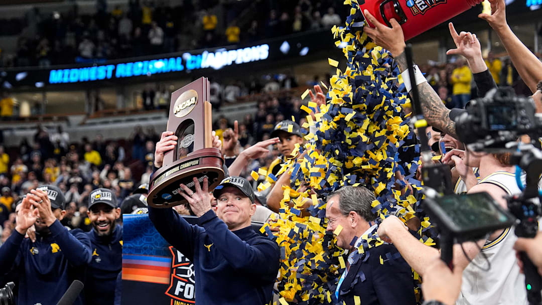 Michigan coach Dusty May celebrates after the Wolverines beat Illinois in the Midwest Regional final to advance to the Final Four.