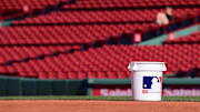 Jun 28, 2024; Boston, Massachusetts, USA;    A bucket of baseballs sits on the grass before a game between the Boston Red Sox and the San Diego Padres at Fenway Park. Mandatory Credit: Eric Canha-Imagn Images