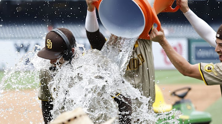 Jul 25, 2024; Washington, District of Columbia, USA; San Diego Padres pitcher Dylan Cease (84) is doused with a Gatorade cooler by Padres third baseman Manny Machado (13) and Padres third baseman Tyler Wade (14) while waiting for an on-air interview after throwing a no-hitter against the Washington Nationals at Nationals Park. Mandatory Credit: Geoff Burke-Imagn Images Jul 25, 2024; Washington, District of Columbia, USA; San Diego Padres pitcher Dylan Cease (84) is doused with a Gatorade cooler by Padres third baseman Manny Machado (13) and Padres third baseman Tyler Wade (14) while waiting for an on-air interview after throwing a no-hitter against the Washington Nationals at Nationals Park. Mandatory Credit: Geoff Burke-Imagn Images