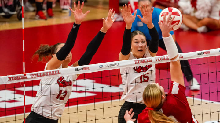 Nebraska outside hitter Merritt Beason & middle blocker Andi Jackson go up to block Wisconsin outside hitter Sarah Franklin 