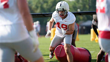 Ohio State Buckeyes defensive lineman Logan George (48) hits a tackling dummy during football training camp at the Woody Hayes Athletic Center on Aug. 1, 2025.